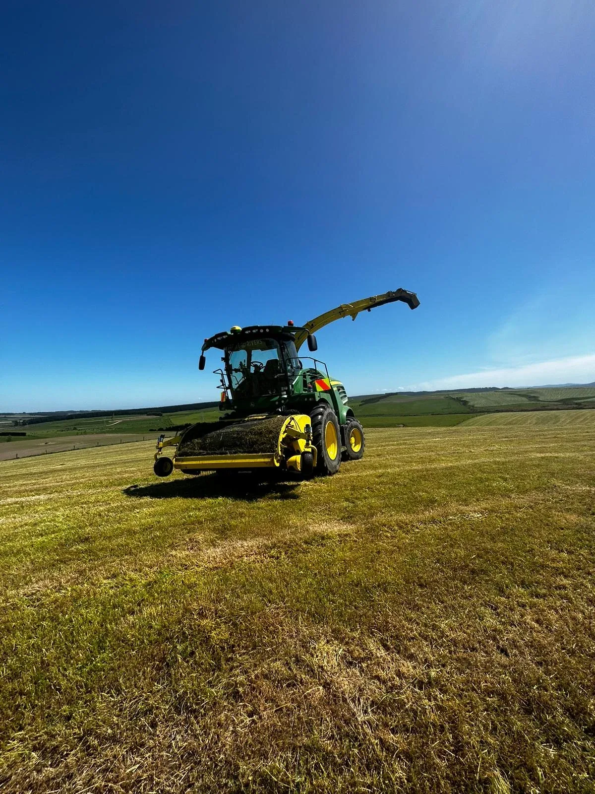 Mowing and silage harvesting in a Southland field.